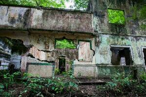 Remains of the destroyed houses of the Armero Town covered by trees and nature after 37 years of the tragedy caused by the Nevado del Ruiz Volcano in 1985 photo