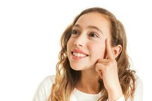 Beautiful young girl thinking or having an idea isolated on white background photo