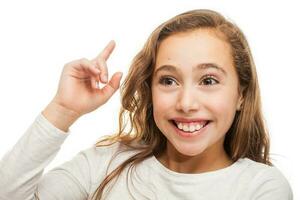 Beautiful young girl thinking or having an idea isolated on white background photo