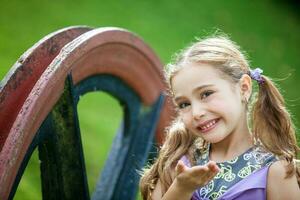 Sweet six years old blonde girl outdoors photo