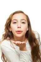 Young girl blowing a kiss to the camera isolated on white background photo