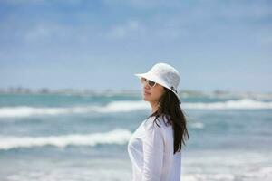 Woman walking at an empty paradisiac tropical beach in a beautiful sunny day photo