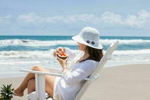 Woman relaxing at a paradisiac tropical beach in a beautiful sunny day photo