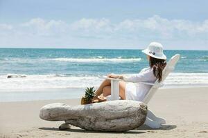 Woman relaxing at a paradisiac tropical beach in a beautiful sunny day photo