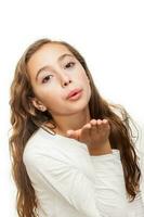 Young girl blowing a kiss to the camera isolated on white background photo