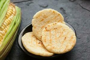 Roasted traditional South American corn arepa photo