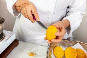 Preparation of the traditional dish from the Caribbean Coast in colombia called Arepa de Huevo or egg arepa photo
