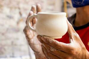 Ceramics on the elaboration process at a traditional factory at the small city of Raquira in Colombia photo