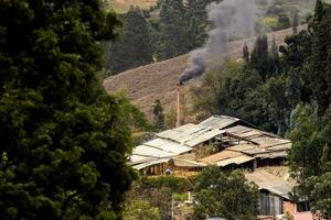 Chimney of a traditional factory during ceramics firing at the small city of Raquira. The city of pots, Colombia photo