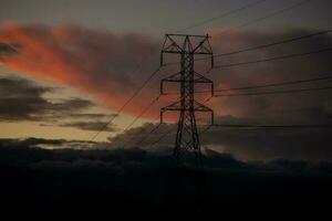 Power tower against a dramatic beautiful sunset sky photo