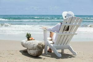 Woman relaxing at a paradisiac tropical beach in a beautiful sunny day photo