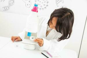 Young girl playing a life sciences professional role. Could be biologist, doctor, researcher. Dreaming about the future. photo