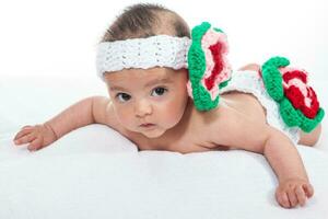 Sweet four months baby girl wearing a crocheted headband photo