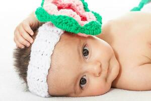 Sweet four months baby girl wearing a crocheted headband photo