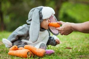 Little baby girl wearing a rabbit costume. Halloween concept photo