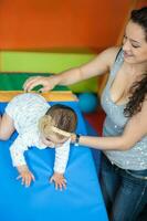 Portrait of a beautiful nine months baby playing with her mom. Crawling baby photo