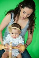 Portrait of a beautiful nine months baby playing with her mom. photo