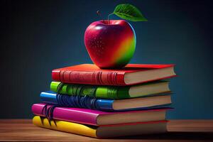 apple and plum near the stack of books on the table in the garden. photo