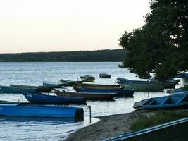 Lots of wooden boats by the lake. photo