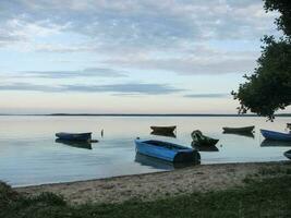 Lots of wooden boats by the lake. photo