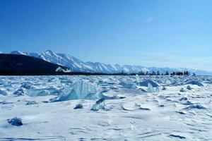 shore of Lake Baikal in winter. Snow and ice on the baikal. photo