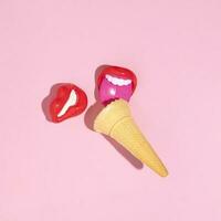 Ice cream cone and girl's lips lollipops, creative summer fun concept, candy pink background. photo