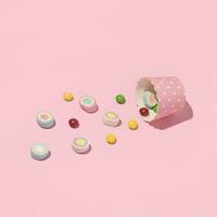 Colorful candy layout, pastel pink background. photo