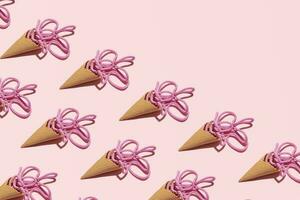 Ice cream cones, pink braided rope creatively arranged, melting fruity ice cream idea, sea marine inspired, summer holiday pattern, candy pink background. photo