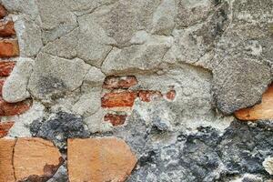 very cracked old wall background texture with red bricks inside photo