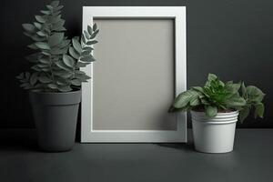 Home decoration - blank picture frame and flower pot on wooden table, photo
