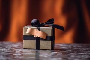 Paper gift with black ribbon, photo