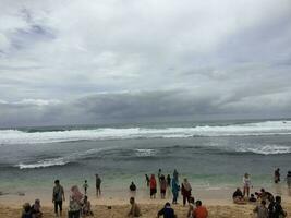 Local tourists play on Slili Beach photo