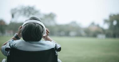 Senior woman enjoy with music frome headphone in park photo