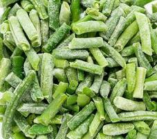 Frozen cut green string beans close up as background. Real food. Sustainable consumption. Top view. photo