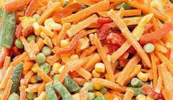 Set of frozen cut vegetables close up as background. Top view. Horizontal format. photo