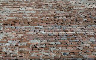 Empty old grunge weathered vintage brick wall. Bottom view. Low angle. Perspective view. Copy space. photo