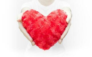 Woman holding and protecting a red heart shape on white background close-up,Symbol of love or dating Valentines day photo