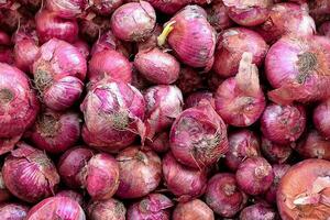 Red onions in plenty on display at local farmer's market, Big fresh red onions background photo