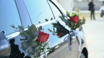 Wedding car decorated with flowers and ribbons, closeup photo