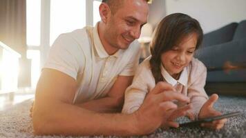 Father and daughter are having fun and painting together. Concept of a happy family and quality leisure time video