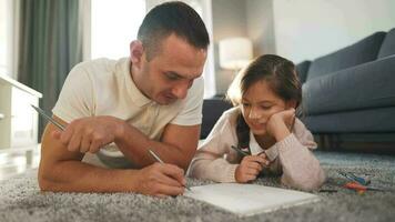 Father and daughter are having fun and painting together. Concept of a happy family and quality leisure time video