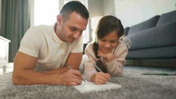 Father and daughter are having fun and painting together. Concept of a happy family and quality leisure time video