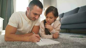 Father and daughter are having fun and painting together. Concept of a happy family and quality leisure time video