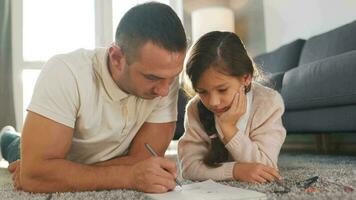 Father and daughter are having fun and painting together. Concept of a happy family and quality leisure time video