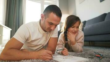 Father and daughter are having fun and painting together. Concept of a happy family and quality leisure time video