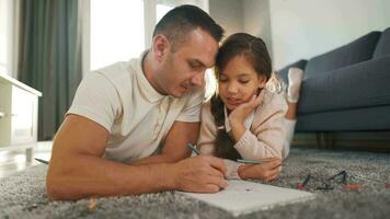 Father and daughter are having fun and painting together. Concept of a happy family and quality leisure time video