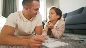 Father and daughter are having fun and painting together. Concept of a happy family and quality leisure time video