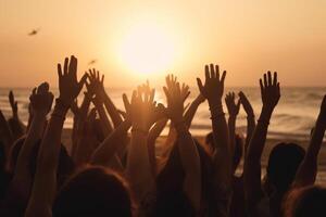 Cheering crowd with hands in the air, summer vacation image, Bokeh People have fun at sunset on a beach, photo