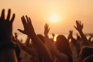 Cheering crowd with hands in the air, summer vacation image, Bokeh People have fun at sunset on a beach, photo