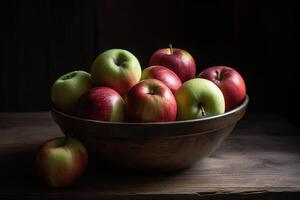 A bowl of apples on a wooden table, photo